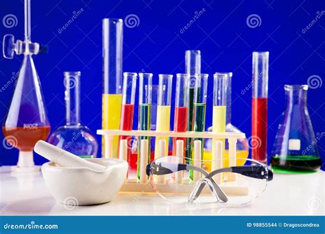 Chemistry Lab Equipment Set On A Table Over Blue Background Stock Photo