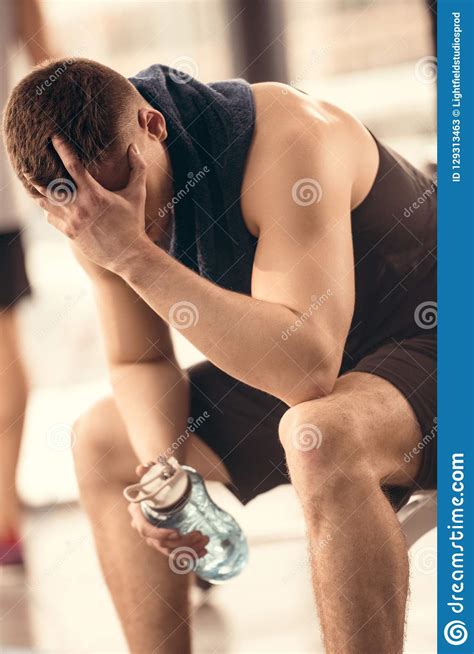 Tired Sportsman Holding Bottle Of Water And Resting Stock Image Image