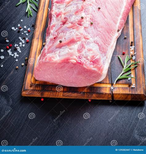 Big Whole Piece Of Pork Meat With Seasoning On Chopping Board On Stock