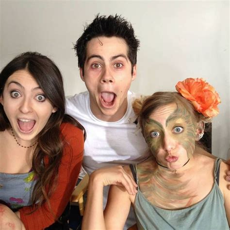 Three People Posing For The Camera With Their Faces Painted