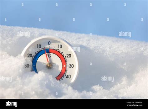 Thermometer With Celsius Scale In The Snow Showing Minus 5 Degree Ambient Temperature Winter