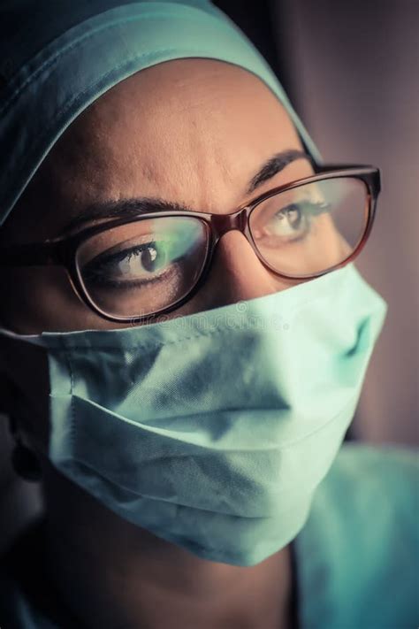 Woman Doctor Wearing A Surgical Mask And Glasses Stock Image Image Of