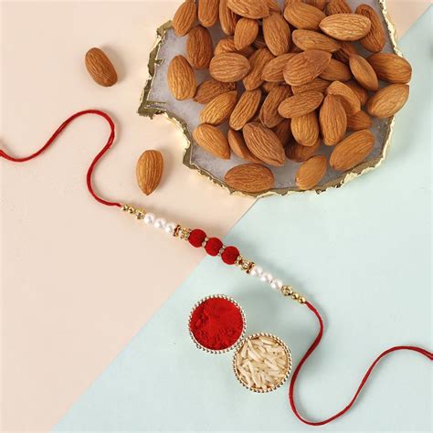 Send White Pearl And Velvet Beads Rakhi With Grams Almonds Online