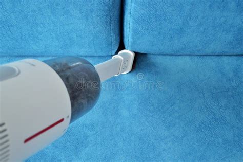 White Handheld Vacuum Cleaner Vacuums the Blue Sofa Stock Image - Image of service, home: 197677167