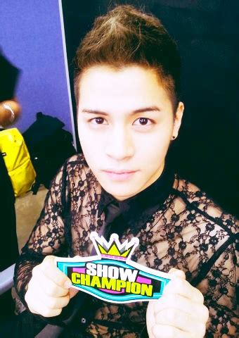 A Woman Holding Up A Sign With The Word Show Champion On It In Front Of