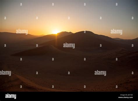 Sunrise above dunes in Namib Desert, Namibia Stock Photo - Alamy