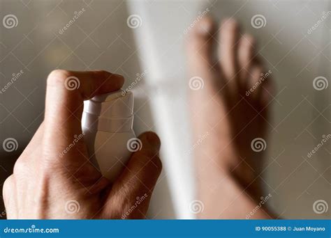 Young Man Applying Deodorant To His Feet Stock Photo Image Of