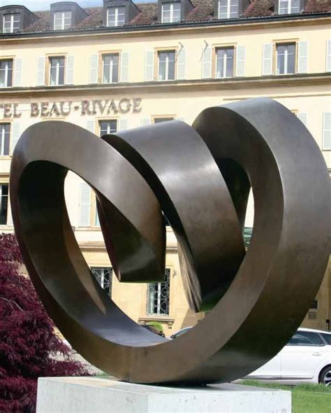 A Large Metal Sculpture In Front Of A Building