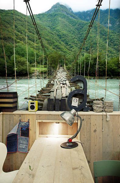 A Wooden Table Sitting On Top Of A River Next To A Forest Filled