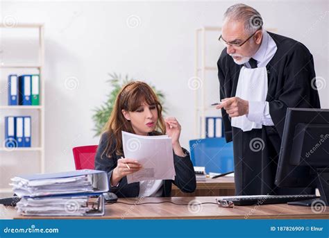 Old Male Judge And His Young Secretary In The Office Stock Image