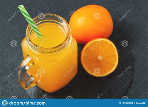 Homemade Freshly Squeezed Orange Juice In A Masonic Jar And Oranges On