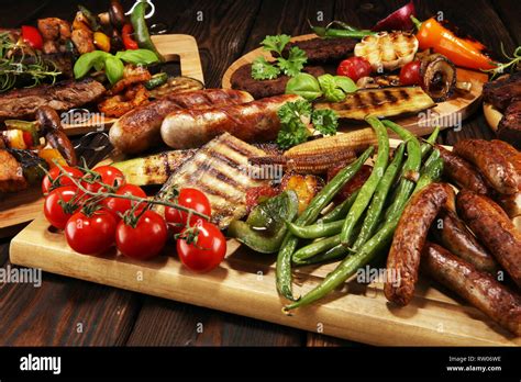 Assorted Delicious Grilled Meat With Vegetable And Herbs On Rustic