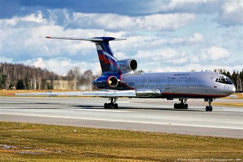 An Airplane That Is Sitting On The Tarmac With Its Wheels Down And It S