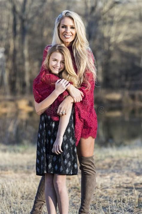 Gorgeous Blonde Model Posing With Her Teenage Daughter Stock Photo