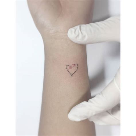 Flower Heart Tattoo Located On The Wrist Minimalistic