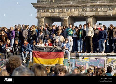 Fall of the Berlin Wall: people from East and West Berlin climbing on ...