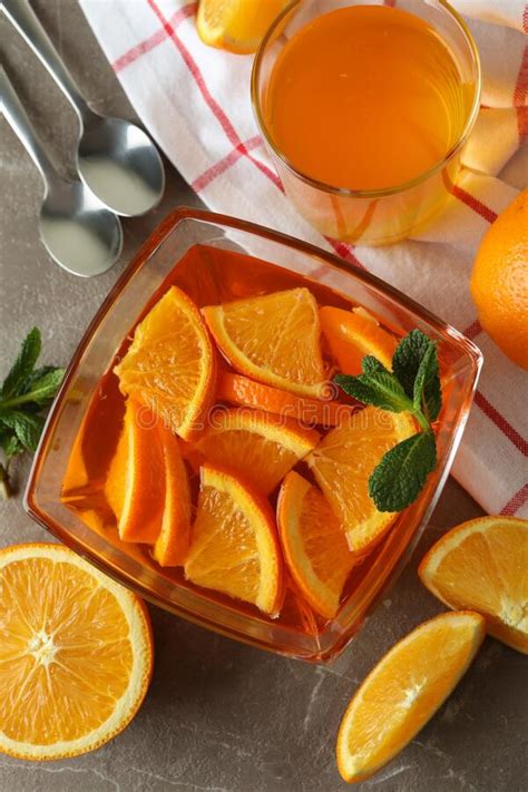 Concept Of Dessert With Bowl Of Orange Jelly With Orange Slices On Gray Table Stock Image