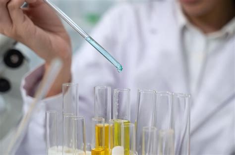 Premium Photo Scientist Dropping Liquid Into Test Tube Sample In