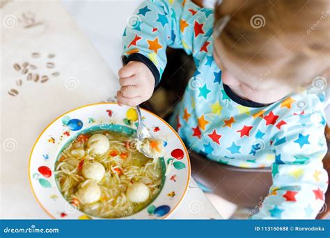 Adorable Baby Girl Eating From Spoon Vegetable Noodle Soup Food Child