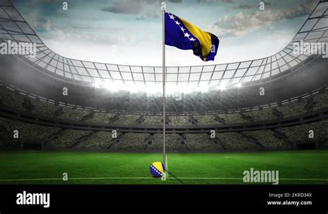 Bosnia and Herzegovina national flag waving on flagpole in football ...