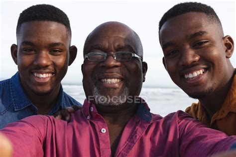 Portrait Of African American Father And His Two Sons Taking A Selfie At