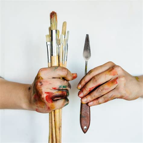 Close Up Of An Artist Painter Hands Holding Paint Brushes Stock Image