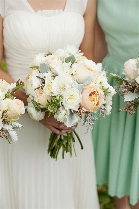 The Bridesmaids Are Holding Their Bouquets With White And Peach Flowers