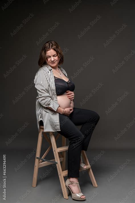 Portrait Of A Pregnant Girl With A Naked Belly Studio Shooting A