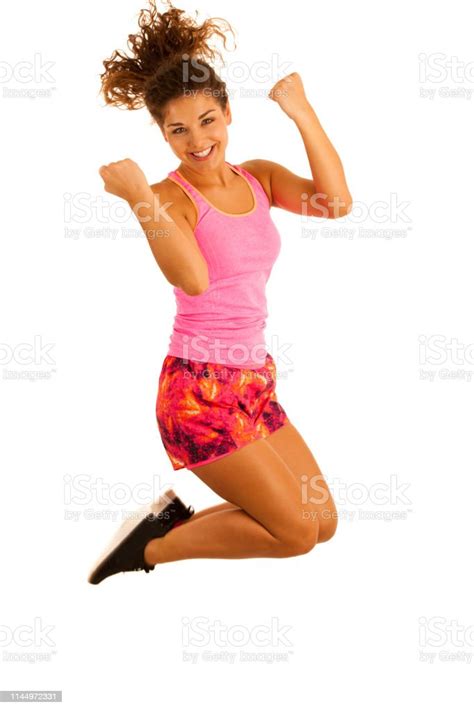 Active Excited Fit Woman Jumps Over White Background Stock Photo