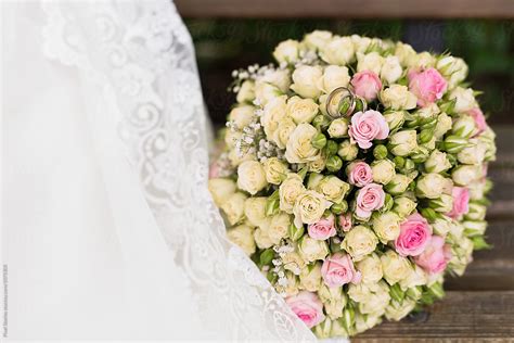 "Pastel Roses Wedding Bouquet Next To A White Dress" by Stocksy ...