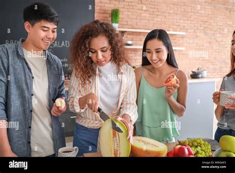 Happy Friends Cooking Together In Kitchen Stock Photo Alamy