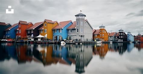 White And Brown Concrete Building Beside Body Of Water During Daytime Photo Free Reitdiephaven