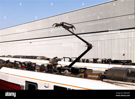 A Raised Pantograph And Electrical Equipment On The Roof Of A Modern