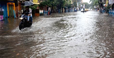 Kolkata Commuters Wade Through Water Logged Road After Heavy Rain