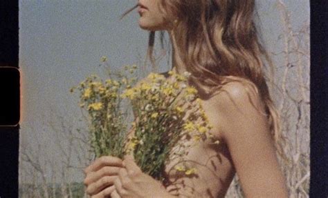 A Woman Holding Flowers In Her Hands