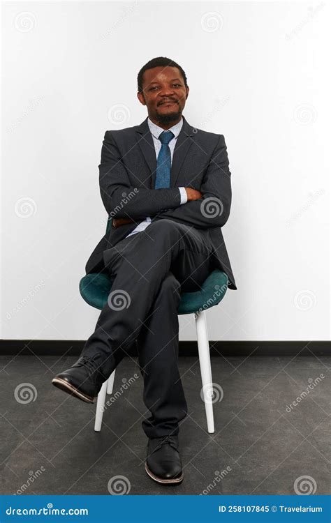 Smiling African American Black Man In Business Suit Sitting On Chair