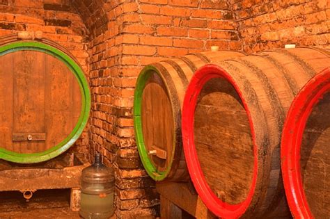 Premium Photo Wine Barrels Stacked In The Old Cellar Of The Winery