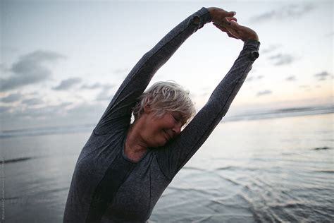 Vibrant Mature Woman Enjoying Herself On The Beach At Sunset Del