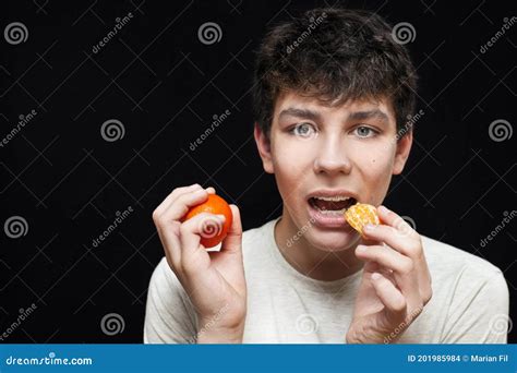 The Guy Holds Tangerines In His Hands And Wants To Eat Them Stock Photo