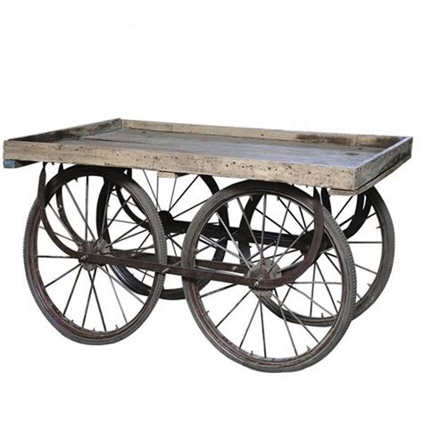 An Old Fashioned Wooden Cart With Wheels On It S Sides And One Wheel