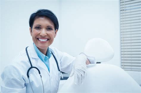 Premium Photo Portrait Of Smiling Female Dentist