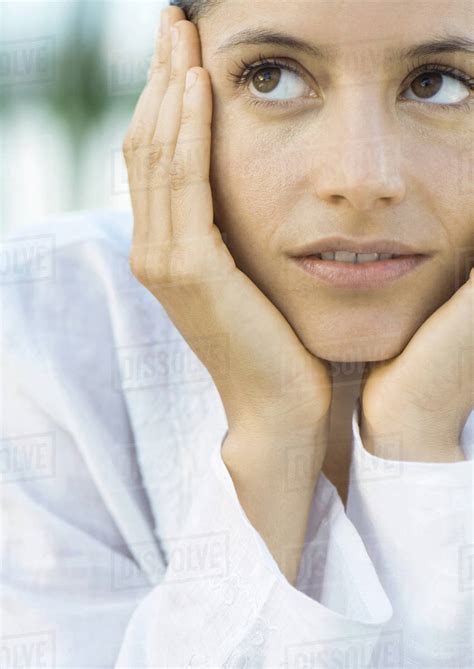 Woman Resting Head In Hands Looking Up Stock Photo Dissolve