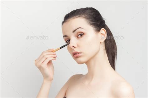 Cheerful Brunette Naked Shoulders Brush In Hands Applying Cream Stock Photo By Shotprime