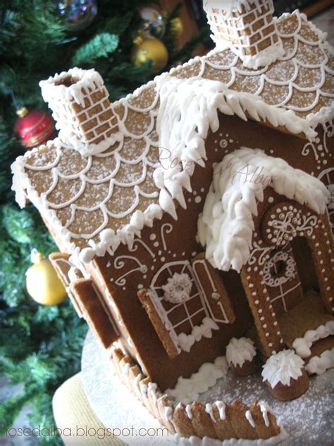 A Gingerbread House Is Decorated With Icing