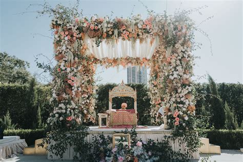 Floral Altar With Pink And White Flowers And The Guru Granth Sahib At