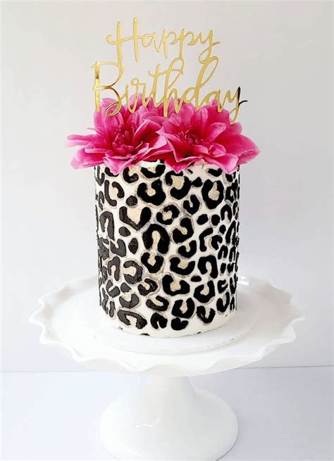 A Leopard Print Birthday Cake With Pink Flowers