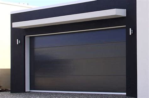 A Black And White House With An Open Garage Door