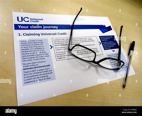 A Universal Credit application form with pen and glasses. Universal ...