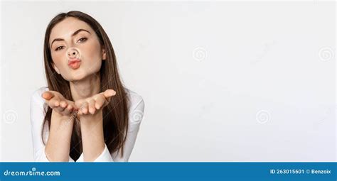 Feminine Woman Sending Air Kiss At Camera Coquettish Flirty Pose