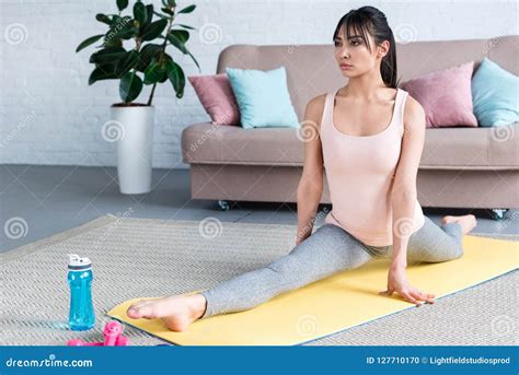 Beautiful Young Woman Practicing Yoga In Front Splits Pose Stock Photo